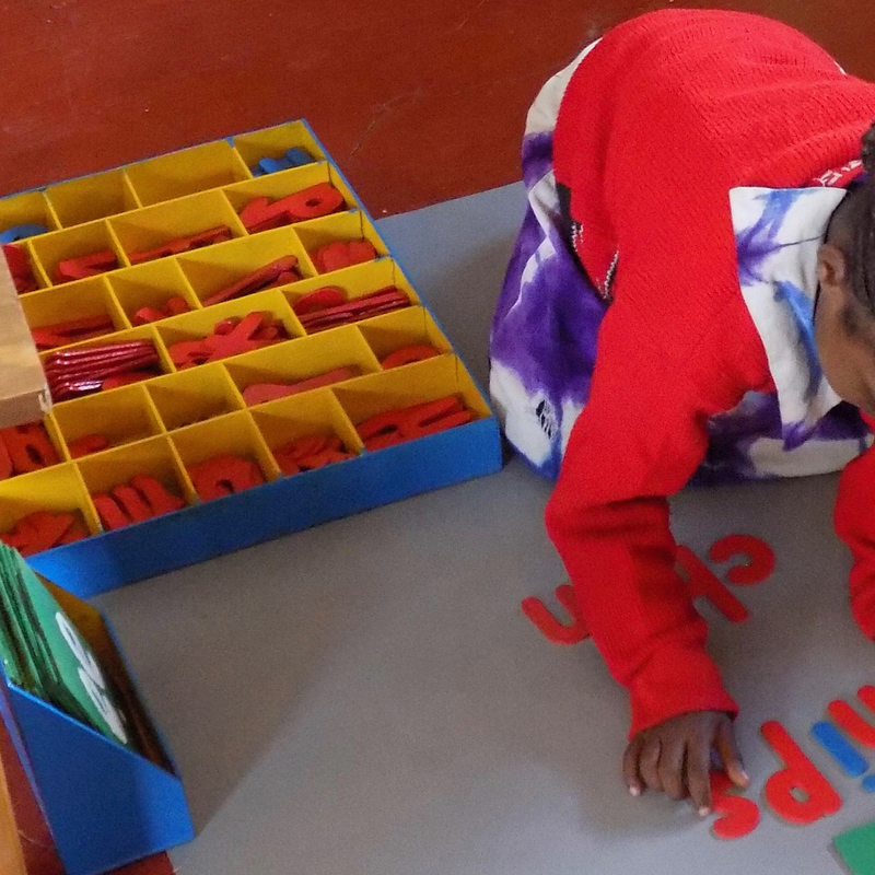 Child using moveable alphabet