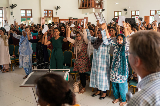 St. Bridget's AMI Training Center students raising hands and singing